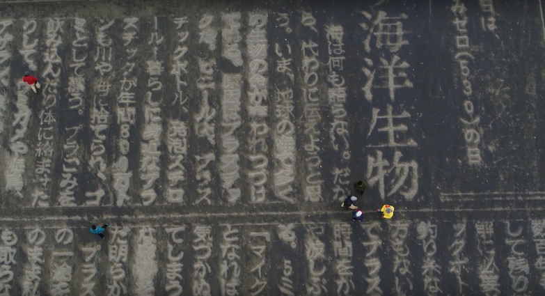 沙灘巨型報紙頭條！《東京新聞》沙雕藝術頭版呼籲正視海洋保育與污染